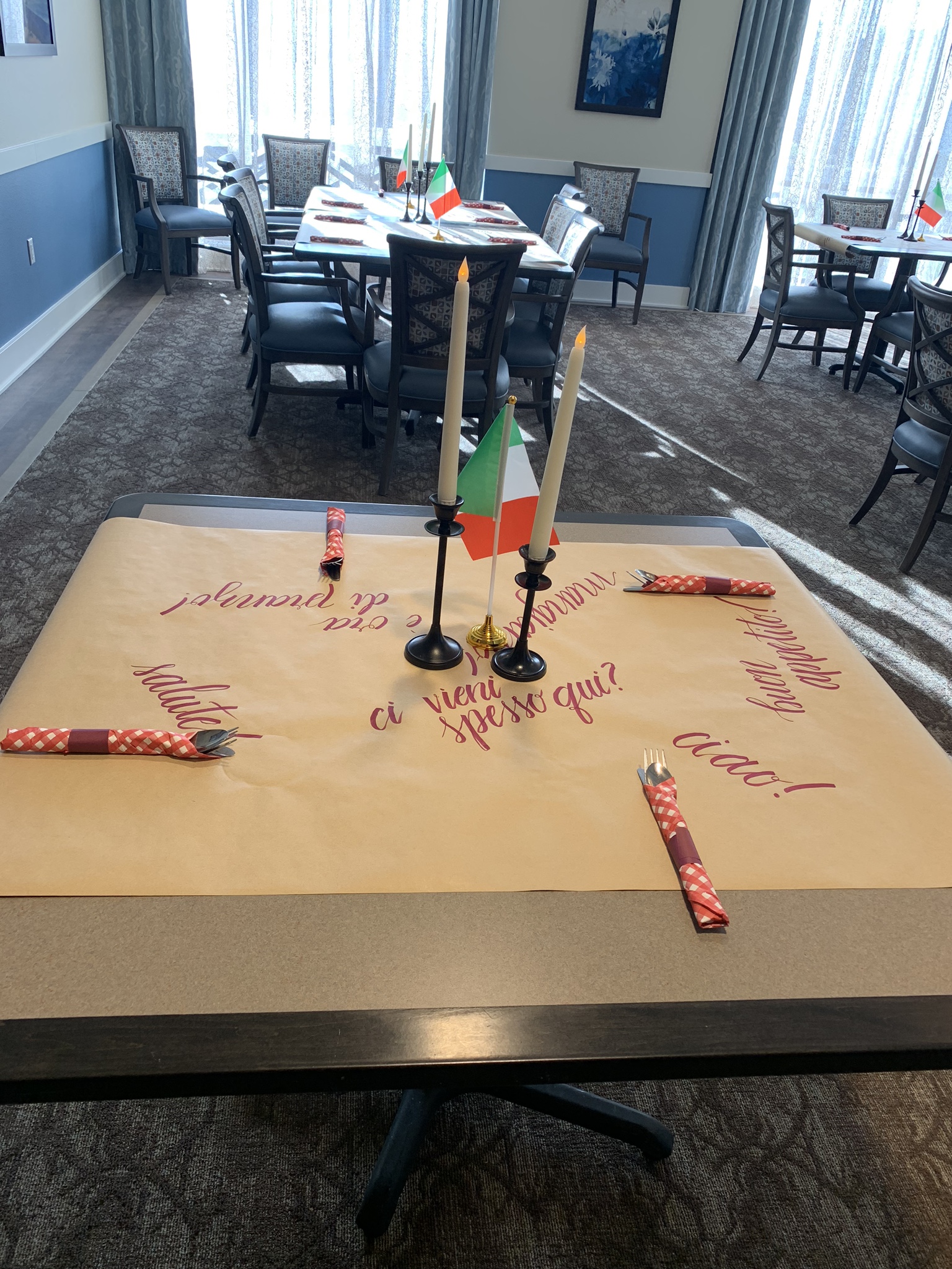Italian Night Tablescape — Themed dining room setup with Italian flags and hand-lettered table runners.