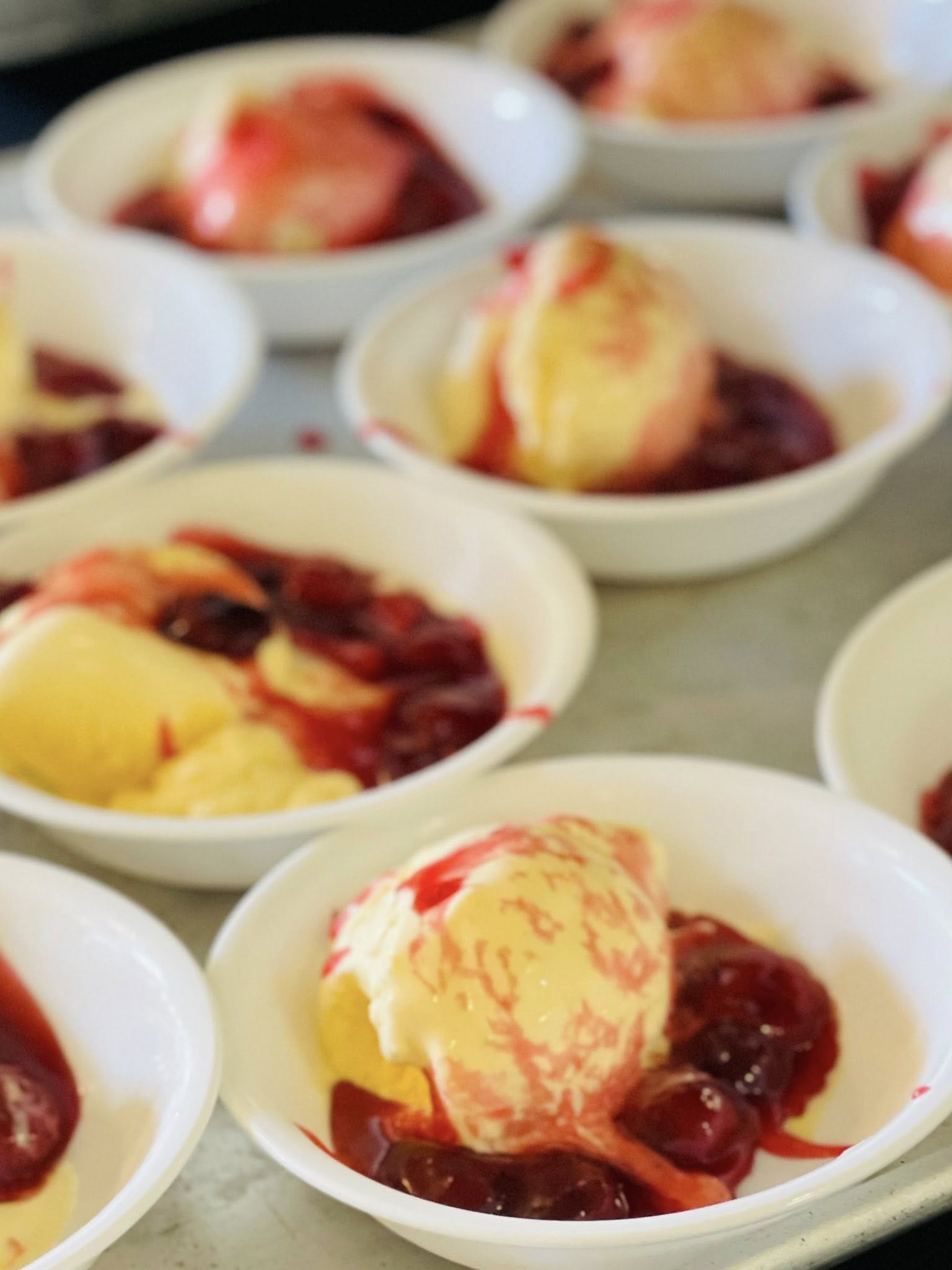 Cherries Jubilee Dessert — House-made cherry sauce over vanilla ice cream — plated for resident dessert service.