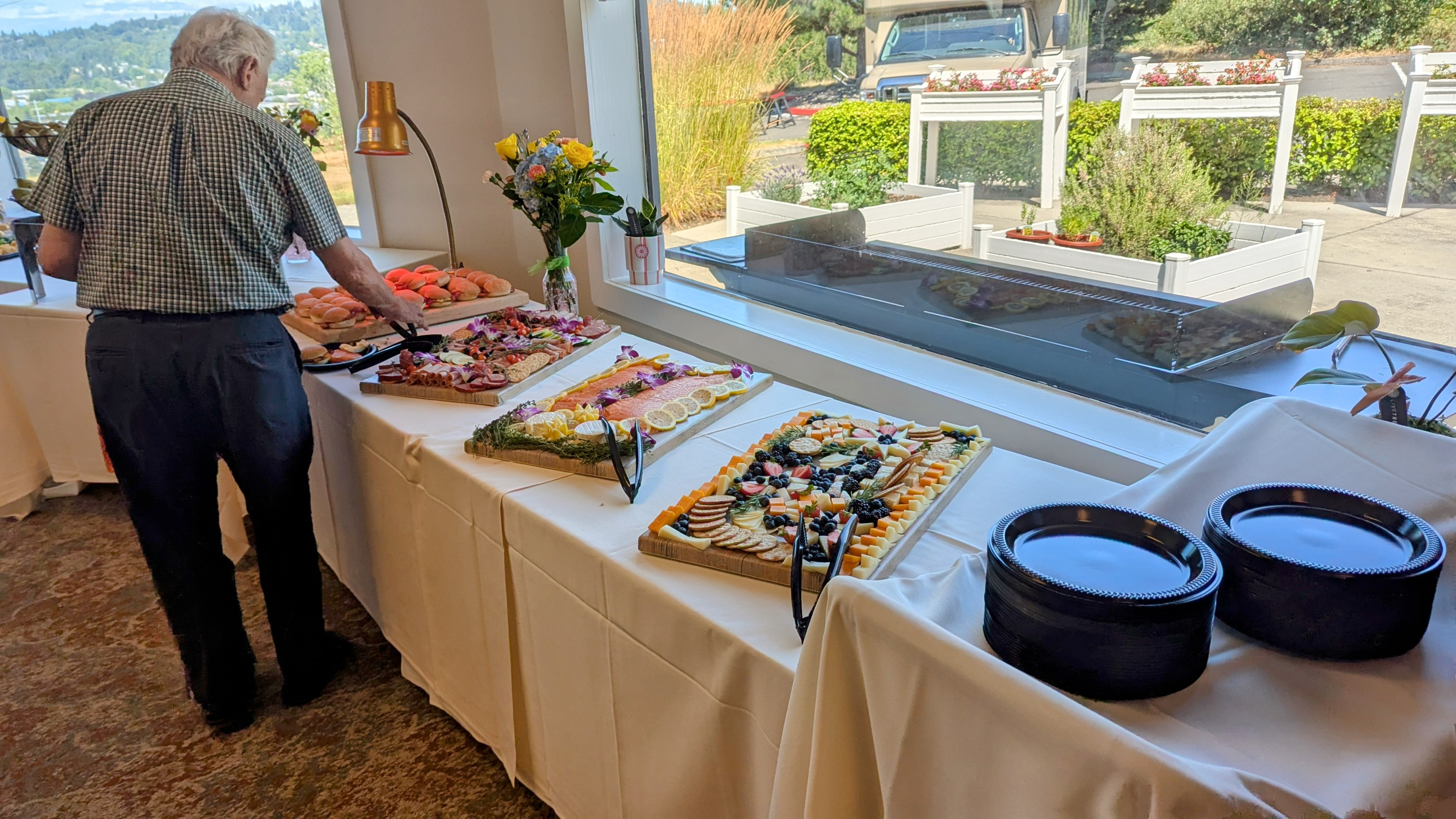 Charcuterie & Smoked Salmon Buffet — Smoked salmon, cured meats, cheeses, and fresh fruit arranged for a resident dining event.